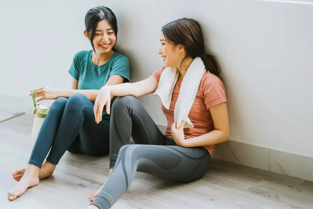 Two women enjoying a chat post Pilates session.