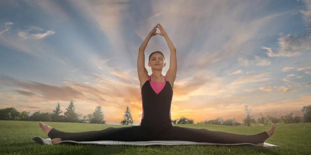 Woman doing yoga outside, how is pilates different from yoga?