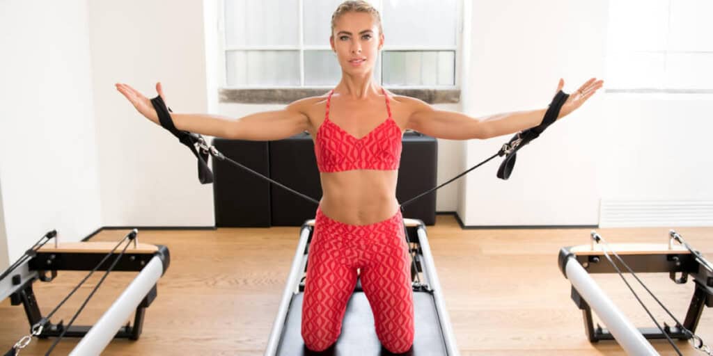 Kneeling on a Pilates reformer