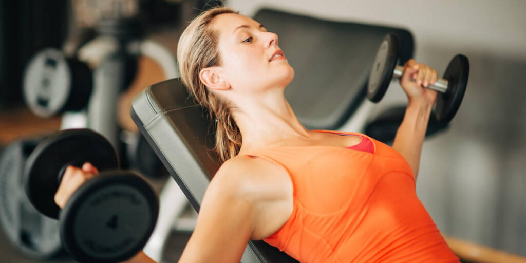 Woman lifting weights at a gym