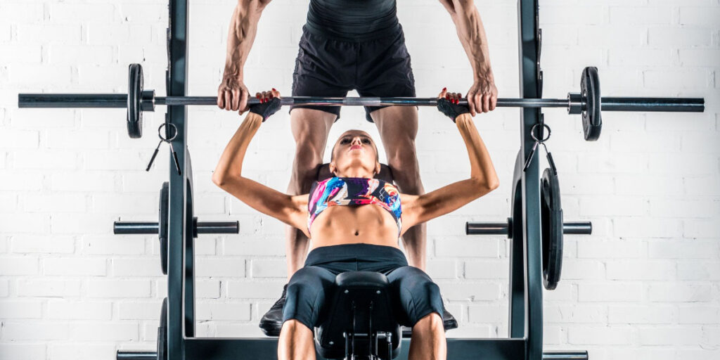 woman bench pressing weights