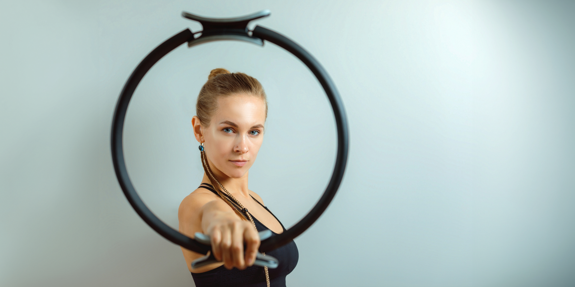 Woman holding pilates ring