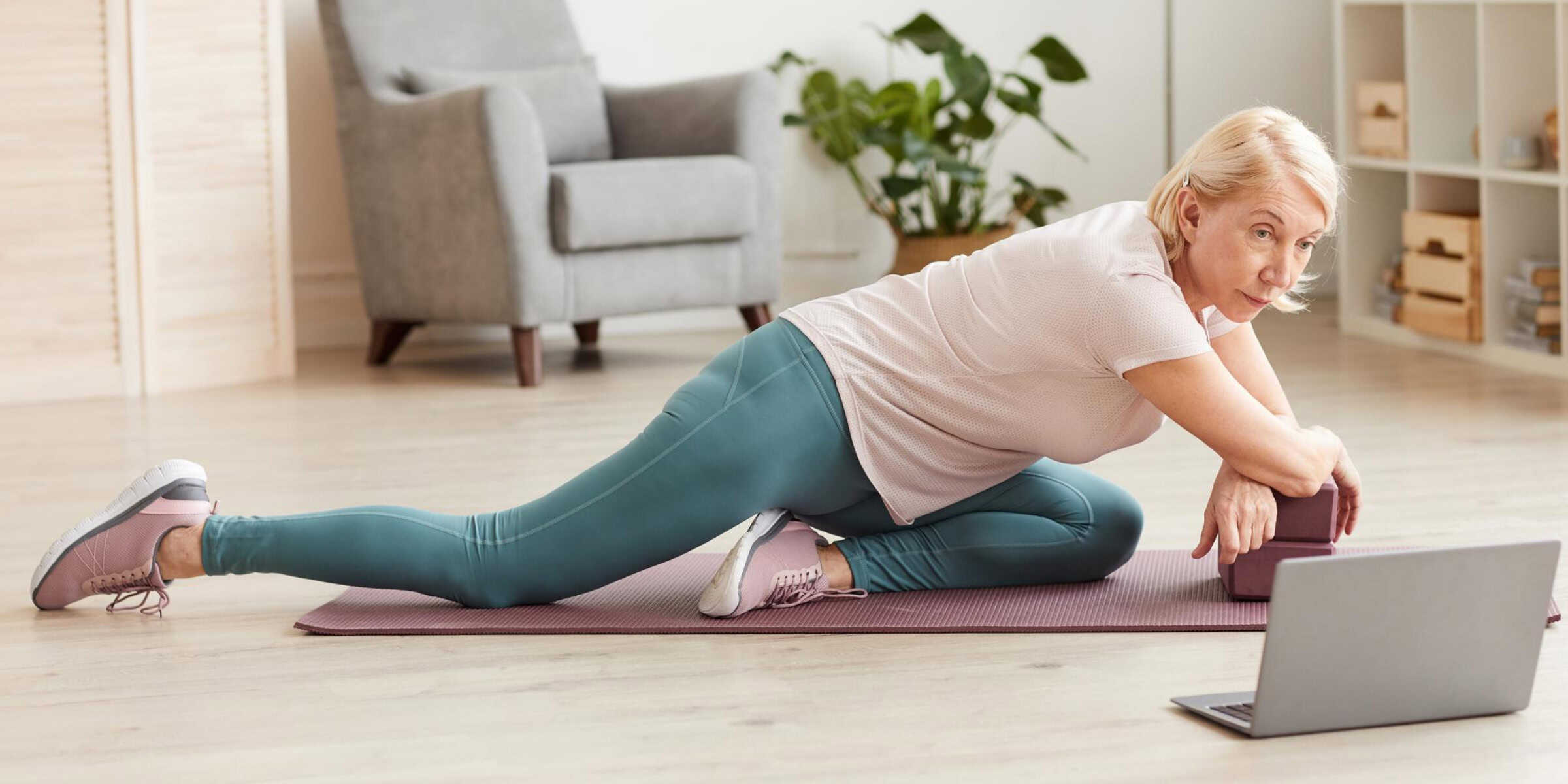 senior woman doing pilates at home