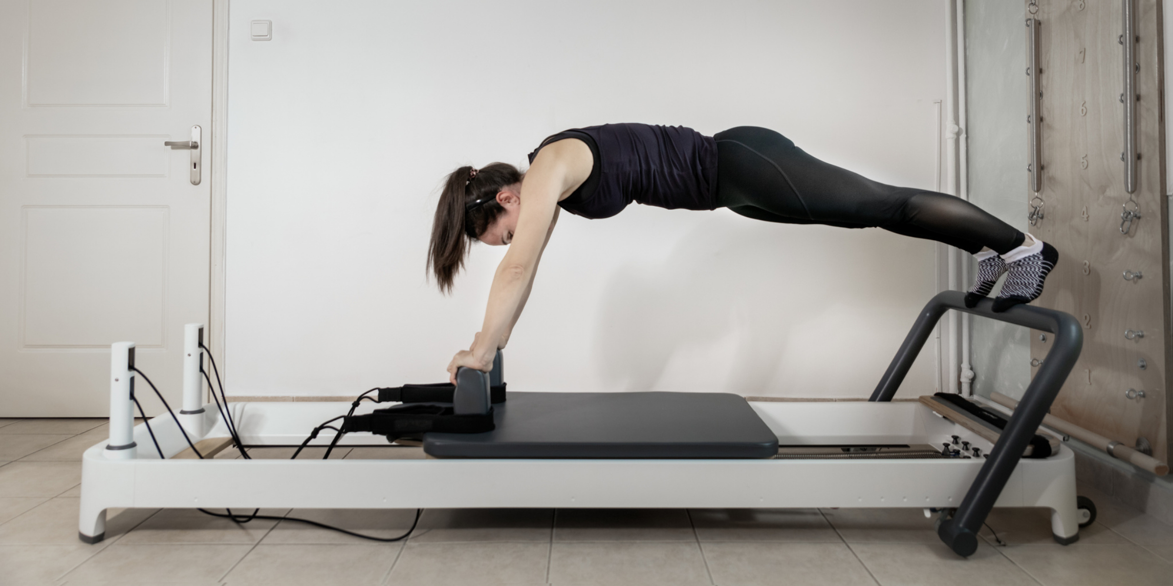 woman planking on reformer