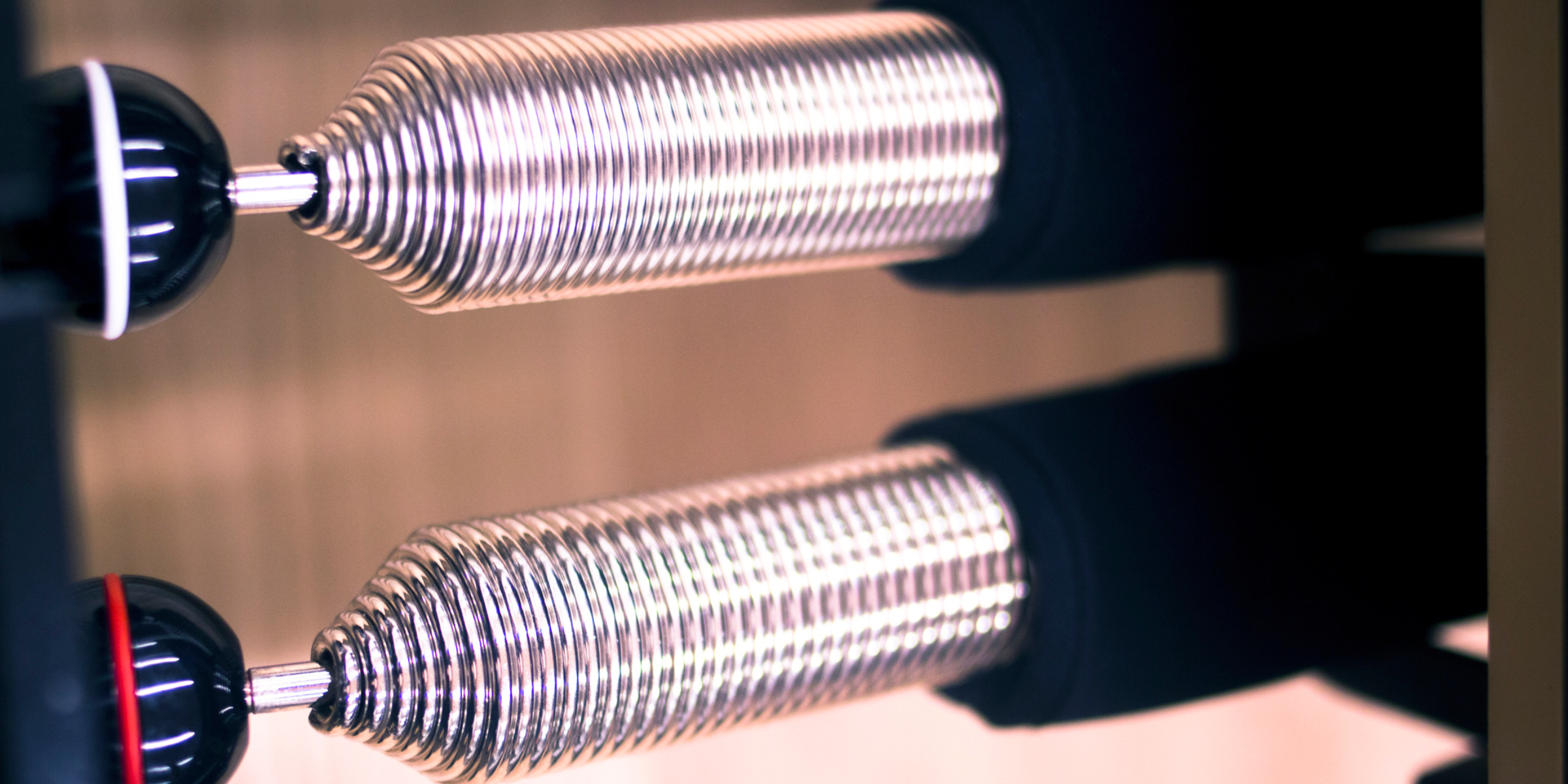 A close up of a pair of metal tubes.