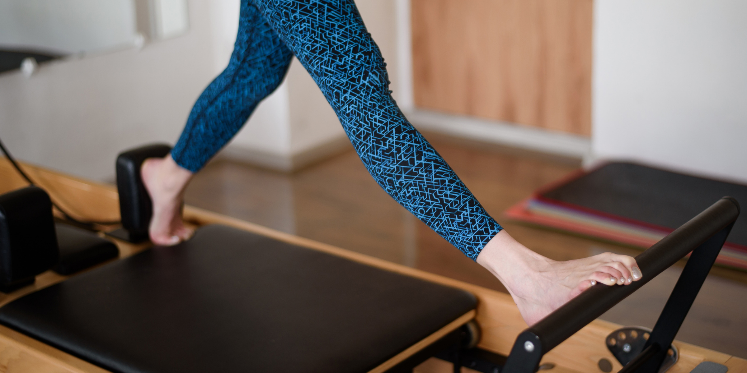 A woman's legs on a pilates machine.