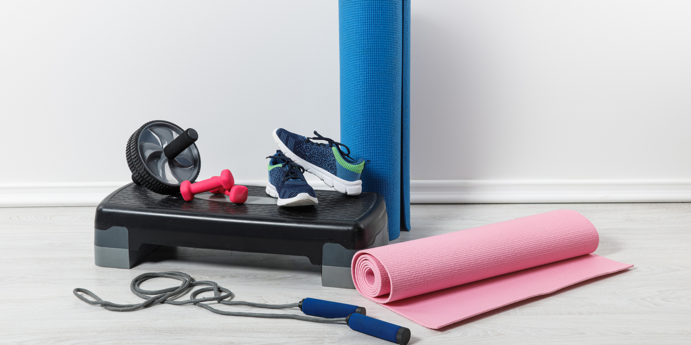 A set of exercise equipment, including a pair of shoes and a yoga mat.